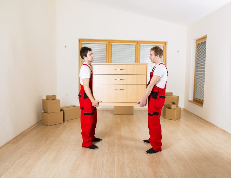 movers-in-new-house-with-lot-of-boxes-behind-them-SBI-305121476-scaled