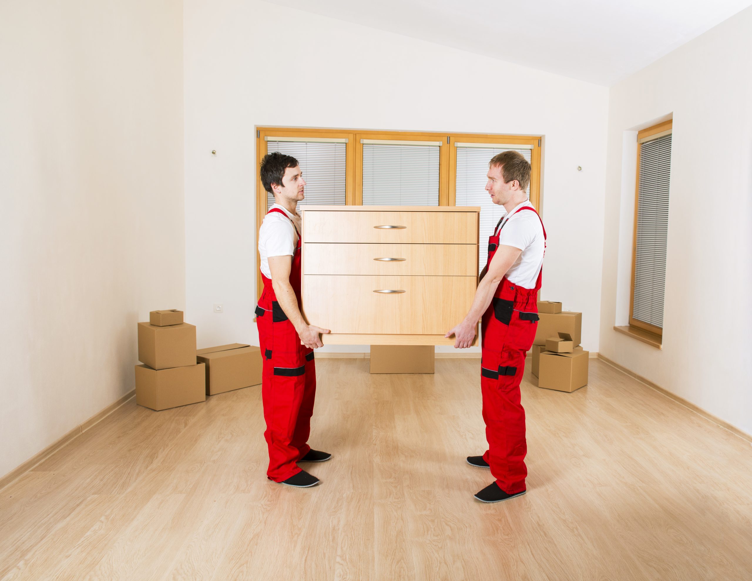 movers-in-new-house-with-lot-of-boxes-behind-them-SBI-305121476-scaled